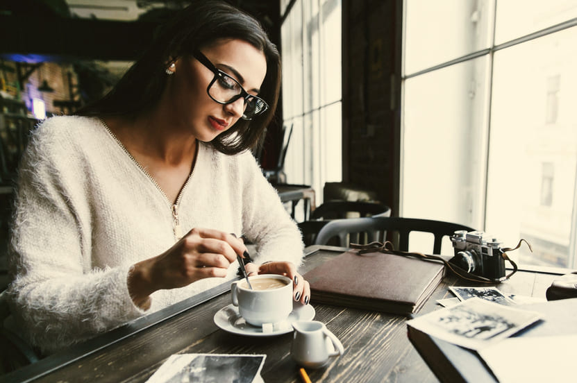 thoughtful woman stirs sugar cup coffee thoughtful-woman-stirs-sugar-cup-coffee
